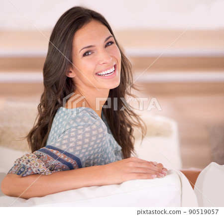 Enjoying the quiet of home. Cropped portrait of a beautiful young woman relaxing at home. 90519057