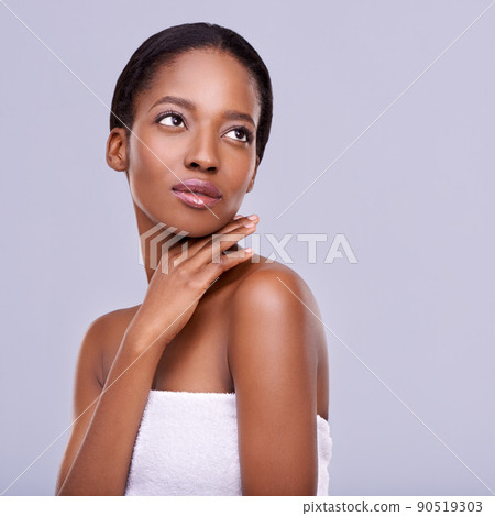 Enhancing her natural beauty. Cropped shot of a beautiful young woman against a purple background. Enhancing her natural beauty. Cropped shot of a beautiful young woman against a purple background. 90519303