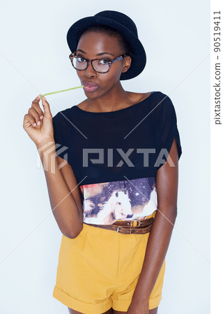 Expressing her childlike side. A young woman posing against white. Expressing her childlike side. A young woman posing against white. 90519411