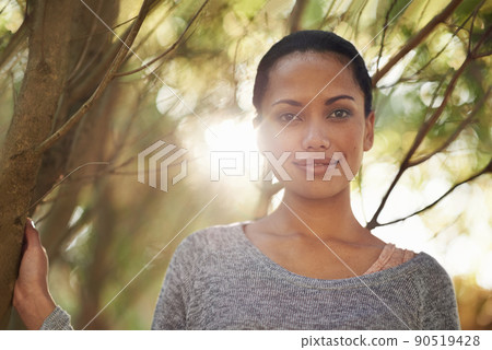 In love with nature. Portrait of a confident young woman standing with her arms folded outdoors. 90519428