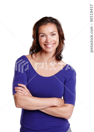 Simplistic Sophistication. Portrait of a woman isolated on white standing with her arms folded and smiling widely. Simplistic Sophistication. Portrait of a woman isolated on white standing with her arms folded and smiling widely. 90519457