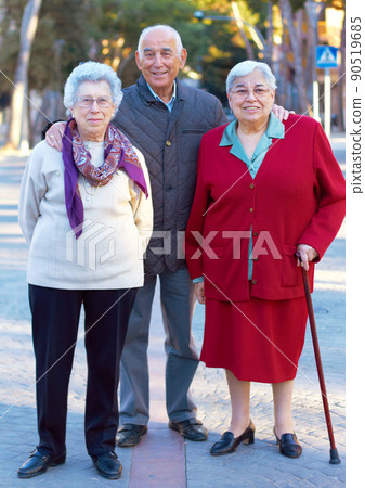 Getting older gracefully. Portrait of three elderly people standing outdoors. Getting older gracefully. Portrait of three elderly people standing outdoors. 90519685