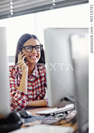 Im so excited and I just cant hide it. Shot of a young designer talking on her phone. Im so excited and I just cant hide it. Shot of a young designer talking on her phone. 90519781