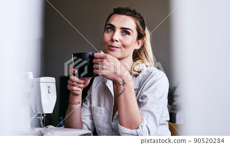 Coffee is what stimulates creative thinking. Cropped shot of a fashion designer having coffee at her desk. Coffee is what stimulates creative thinking. Cropped shot of a fashion designer having coffee at her desk. 90520284