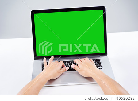 Make your presence felt online. Shot of a person using a laptop with a green screen. Make your presence felt online. Shot of a person using a laptop with a green screen. 90520285