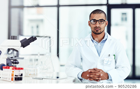 Hes an important part of the scientific lab. Cropped shot of a young male scientist working in his lab. 90520286