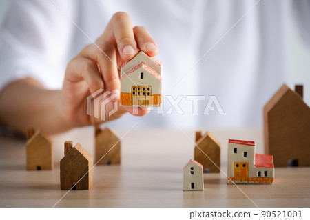 closeup woman hand holding beautiful home model 90521001