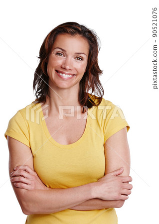 Shes positive about life. A happy young woman standing against a white background. Shes positive about life. A happy young woman standing against a white background. 90521076