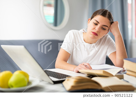 Young girl reads a paragraph in a textbook Young girl reads a paragraph in a textbook 90521122