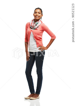 Proud posing. Portrait of a pretty smiling young woman posing with hand on hip against a white background. Proud posing. Portrait of a pretty smiling young woman posing with hand on hip against a white background. 90521123