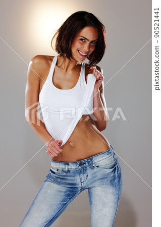 Get your body moving. Studio shot of an attractive woman dancing. 90521441