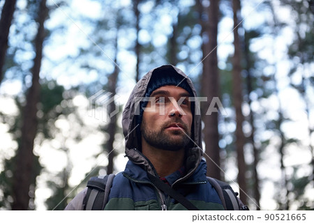 Explore you local wilderness. Cropped shot of a handsome young man hiking in a forest. 90521665