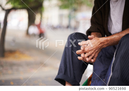 Urban elderly. Cropped shot of an old man sitting outside. 90521698
