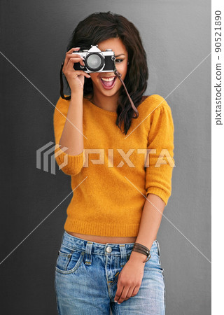 Thats what I like to see. Studio shot of a young woman using a vintage camera against a gray background. Thats what I like to see. Studio shot of a young woman using a vintage camera against a gray background. 90521890