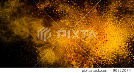 Explosion, Splashes of turmeric on a black background. India Seasoning. The orange powder of the turmeric root. Explosion, Splashes of turmeric on a black background. India Seasoning. The orange powder of the turmeric root. 90522074