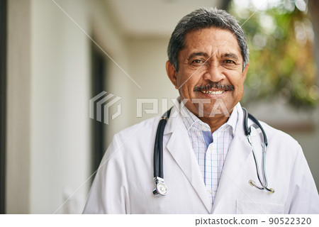 Happy to help you recover. Portrait of a mature male doctor standing outside. Happy to help you recover. Portrait of a mature male doctor standing outside. 90522320