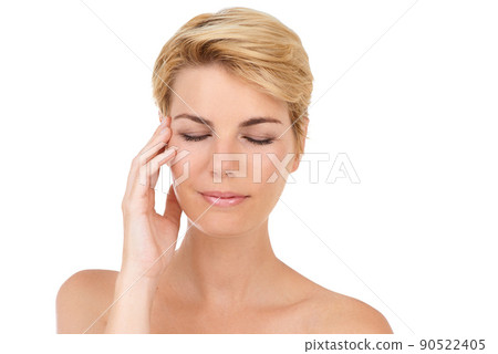 THis new moisturizer is amazing. Cropped shot of a gorgeous young woman isolated on white while touching her skin. 90522405