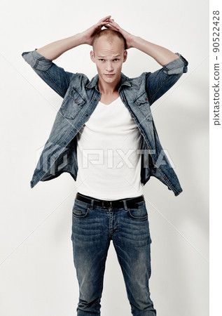 Dressed in all-denim. Studio portrait of a handsome young male model. 90522428