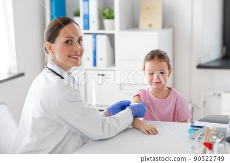 female doctor and little girl patient at clinic 90522749