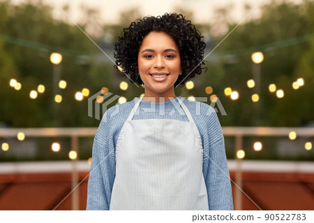 smiling woman in apron over restaurant terrace 90522783