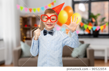 little boy in birthday party hat with glasses 90522854