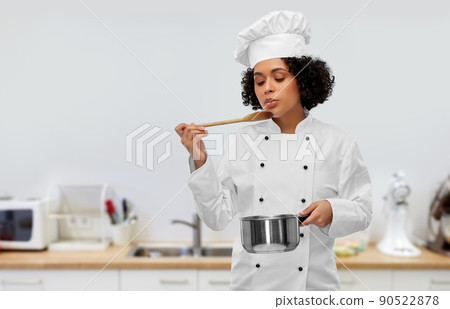 female chef with saucepan and spoon cooking food 90522878