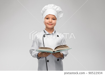 little girl in chef's toque reading cook book little girl in chef's toque reading cook book 90522934