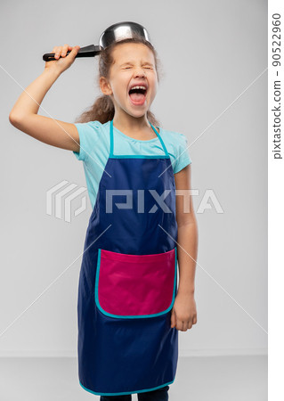 happy little girl in apron playing with saucepan 90522960