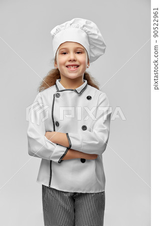 smiling little girl in chef's toque and jacket 90522961