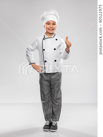 little boy in chef's toque showing thumbs up little boy in chef's toque showing thumbs up 90522975
