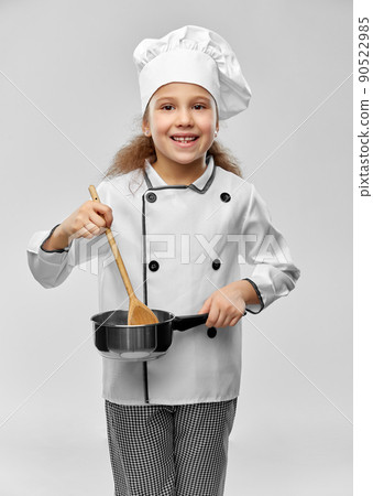 happy girl in chef's toque with spoon and saucepan 90522985