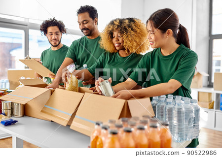 happy volunteers packing food in donation boxes 90522986