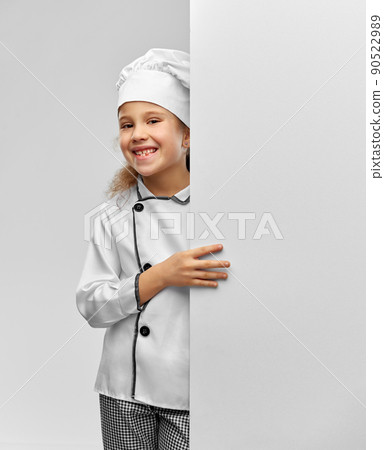 happy little girl in chef's toque with white board 90522989