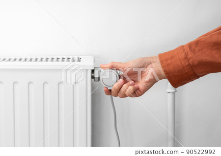 close up of hand turning radiator toggle at home close up of hand turning radiator toggle at home 90522992