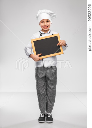 happy little boy in chef's toque with chalkboard happy little boy in chef's toque with chalkboard 90522996