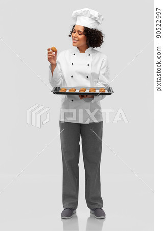 happy female chef with cookies on oven tray happy female chef with cookies on oven tray 90522997