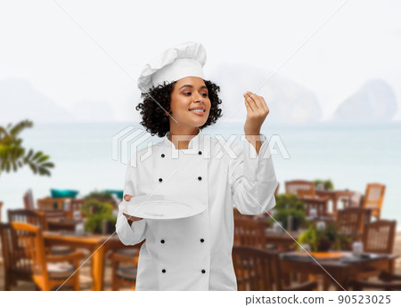 happy smiling female chef holding empty plate happy smiling female chef holding empty plate 90523025