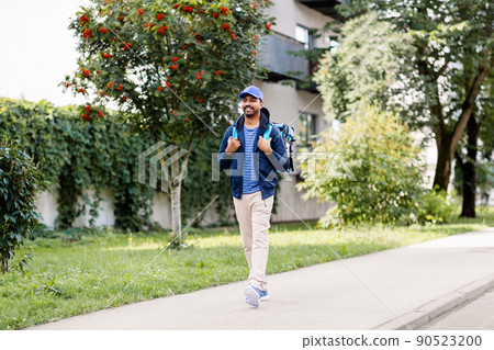 indian delivery man with bag walking in city indian delivery man with bag walking in city 90523200