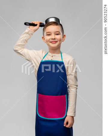 happy little boy in apron playing with saucepan 90523274