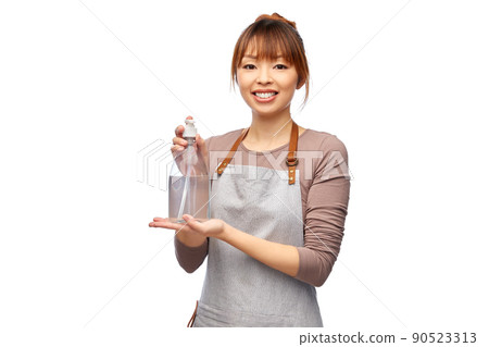 happy woman in apron with hand sanitizer or soap 90523313