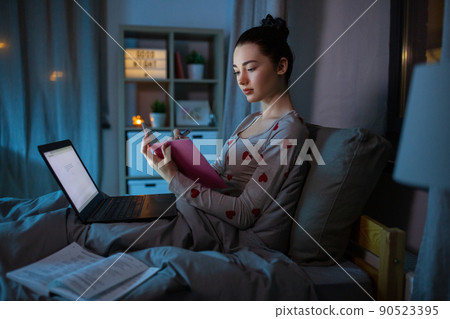 student girl with notebook and laptop at night student girl with notebook and laptop at night 90523395