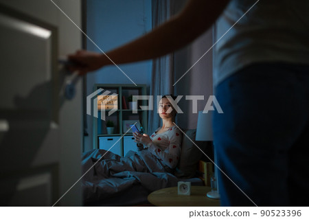 teenage girl with tablet pc in bed at night teenage girl with tablet pc in bed at night 90523396