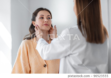 doctor checking lymph nodes of woman at hospital doctor checking lymph nodes of woman at hospital 90523555