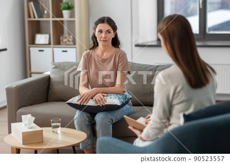 woman and psychologist at psychotherapy session 90523557
