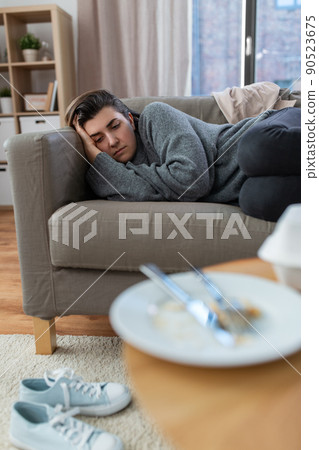 depressed woman lying on sofa at home depressed woman lying on sofa at home 90523675