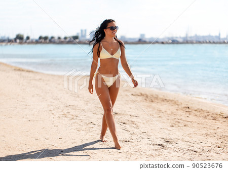smiling young woman in bikini swimsuit on beach smiling young woman in bikini swimsuit on beach 90523676