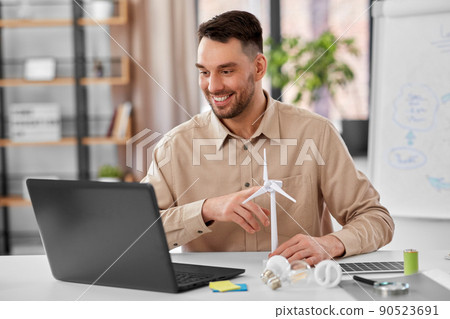 male teacher with laptop and wind turbine at home male teacher with laptop and wind turbine at home 90523691