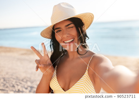 smiling woman in bikini taking selfie on beach smiling woman in bikini taking selfie on beach 90523711