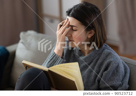 sad woman with diary sitting on sofa at home sad woman with diary sitting on sofa at home 90523712