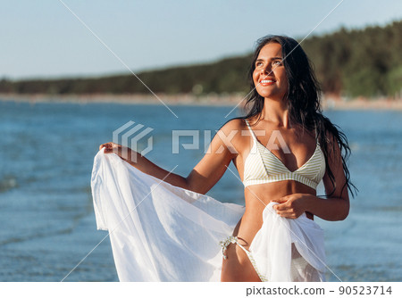 woman in bikini swimsuit with pareo on beach woman in bikini swimsuit with pareo on beach 90523714
